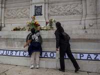 In Lisbon, Portugal, on October 26, 2024, a person holds flowers at an improvised memorial at Praca dos Restauradores. They protest the deat...