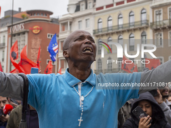 In Lisbon, Portugal, on October 26, 2024, a man cries after praying before an improvised memorial with the picture of Odair Moniz at Praca d...