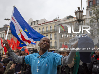 In Lisbon, Portugal, on October 26, 2024, a man cries after praying before an improvised memorial with the picture of Odair Moniz at Praca d...