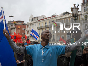 In Lisbon, Portugal, on October 26, 2024, a man cries after praying before an improvised memorial with the picture of Odair Moniz at Praca d...