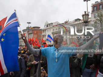 In Lisbon, Portugal, on October 26, 2024, a man cries after praying before an improvised memorial with the picture of Odair Moniz at Praca d...