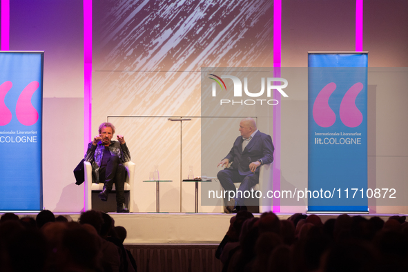 Thomas Johannes Gottschalk, a German television host, and Jorg Thadeusz, a German journalist, are seen on the stage at Flora Hall in Cologne...