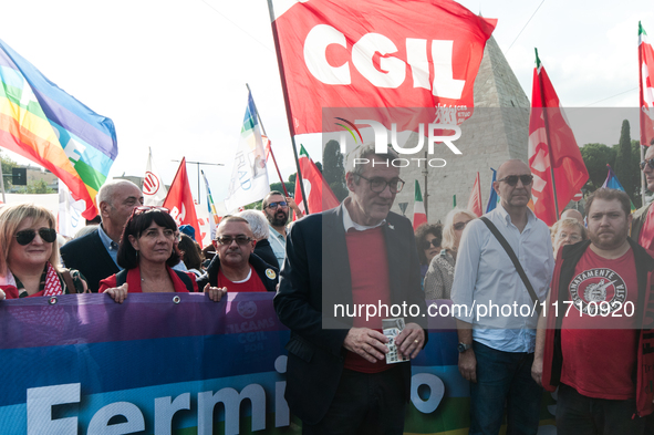 People attend a rally as part of the National Mobilization Day themed 'Let's stop the wars, the time for peace is now' in Rome, Italy, on Oc...