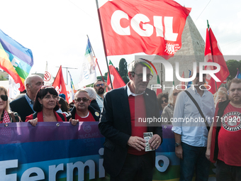 People attend a rally as part of the National Mobilization Day themed 'Let's stop the wars, the time for peace is now' in Rome, Italy, on Oc...