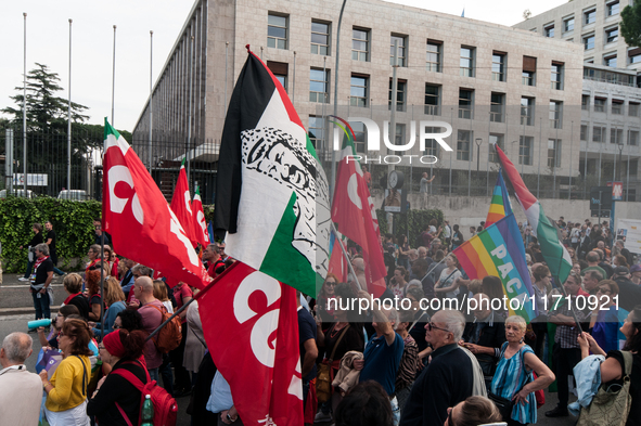 People attend a rally as part of the National Mobilization Day themed 'Let's stop the wars, the time for peace is now' in Rome, Italy, on Oc...