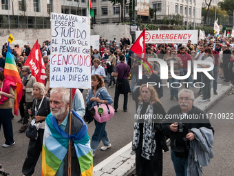 People attend a rally as part of the National Mobilization Day themed 'Let's stop the wars, the time for peace is now' in Rome, Italy, on Oc...