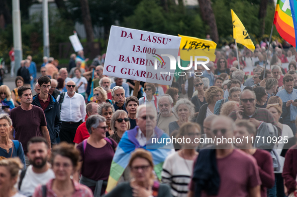 People attend a rally as part of the National Mobilization Day themed 'Let's stop the wars, the time for peace is now' in Rome, Italy, on Oc...