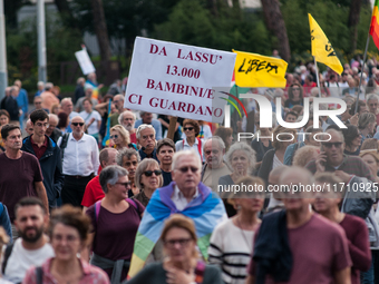 People attend a rally as part of the National Mobilization Day themed 'Let's stop the wars, the time for peace is now' in Rome, Italy, on Oc...