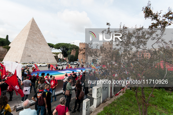 People attend a rally as part of the National Mobilization Day themed 'Let's stop the wars, the time for peace is now' in Rome, Italy, on Oc...