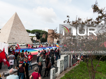 People attend a rally as part of the National Mobilization Day themed 'Let's stop the wars, the time for peace is now' in Rome, Italy, on Oc...