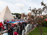 People attend a rally as part of the National Mobilization Day themed 'Let's stop the wars, the time for peace is now' in Rome, Italy, on Oc...