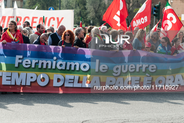 People attend a rally as part of the National Mobilization Day themed 'Let's stop the wars, the time for peace is now' in Rome, Italy, on Oc...