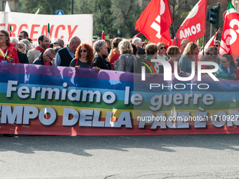 People attend a rally as part of the National Mobilization Day themed 'Let's stop the wars, the time for peace is now' in Rome, Italy, on Oc...