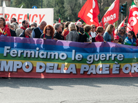 People attend a rally as part of the National Mobilization Day themed 'Let's stop the wars, the time for peace is now' in Rome, Italy, on Oc...