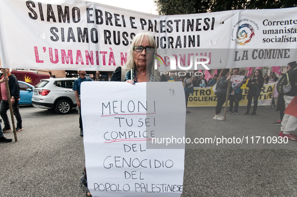 People attend a rally as part of the National Mobilization Day themed 'Let's stop the wars, the time for peace is now' in Rome, Italy, on Oc...