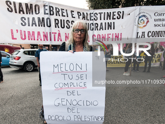 People attend a rally as part of the National Mobilization Day themed 'Let's stop the wars, the time for peace is now' in Rome, Italy, on Oc...