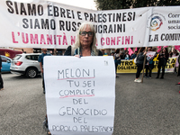 People attend a rally as part of the National Mobilization Day themed 'Let's stop the wars, the time for peace is now' in Rome, Italy, on Oc...