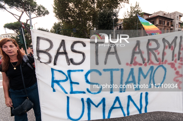 People attend a rally as part of the National Mobilization Day themed 'Let's stop the wars, the time for peace is now' in Rome, Italy, on Oc...