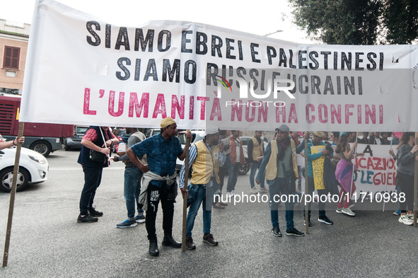 People attend a rally as part of the National Mobilization Day themed 'Let's stop the wars, the time for peace is now' in Rome, Italy, on Oc...