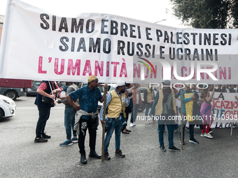 People attend a rally as part of the National Mobilization Day themed 'Let's stop the wars, the time for peace is now' in Rome, Italy, on Oc...