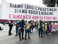 People attend a rally as part of the National Mobilization Day themed 'Let's stop the wars, the time for peace is now' in Rome, Italy, on Oc...