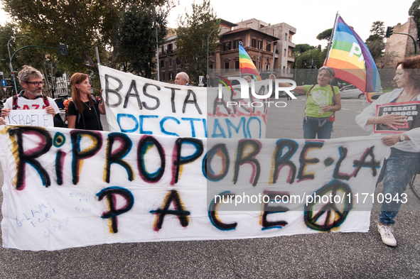 People attend a rally as part of the National Mobilization Day themed 'Let's stop the wars, the time for peace is now' in Rome, Italy, on Oc...