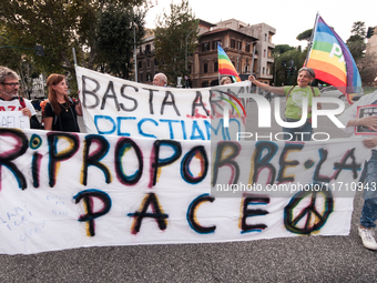 People attend a rally as part of the National Mobilization Day themed 'Let's stop the wars, the time for peace is now' in Rome, Italy, on Oc...