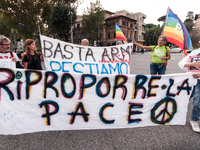 People attend a rally as part of the National Mobilization Day themed 'Let's stop the wars, the time for peace is now' in Rome, Italy, on Oc...