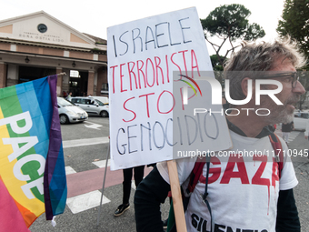 People attend a rally as part of the National Mobilization Day themed 'Let's stop the wars, the time for peace is now' in Rome, Italy, on Oc...