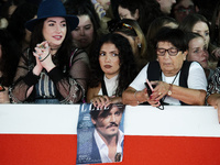 Fans with a Johnny Depp poster wait for the red carpet of the movie ''Modi - Three Days on the Wing of Madness'' during the 19th Internation...