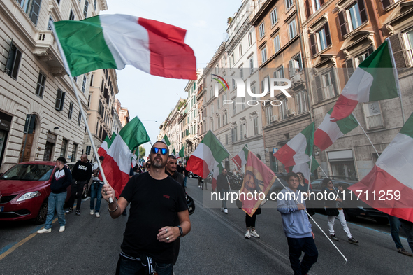 People participate in the demonstration "Italy repudiates war," which is the slogan of the procession that takes place in the streets of Rom...