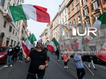 People participate in the demonstration "Italy repudiates war," which is the slogan of the procession that takes place in the streets of Rom...