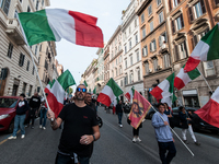 People participate in the demonstration "Italy repudiates war," which is the slogan of the procession that takes place in the streets of Rom...