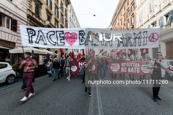 People participate in the demonstration "Italy repudiates war," which is the slogan of the procession that takes place in the streets of Rom...