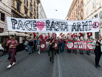 People participate in the demonstration "Italy repudiates war," which is the slogan of the procession that takes place in the streets of Rom...