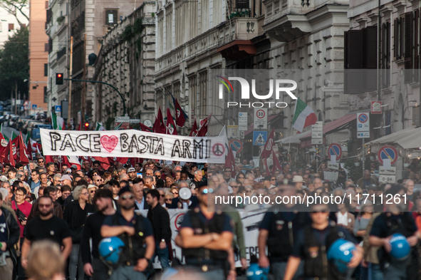 People participate in the demonstration "Italy repudiates war," which is the slogan of the procession that takes place in the streets of Rom...