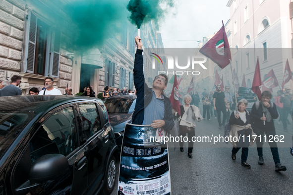 People participate in the demonstration "Italy repudiates war," which is the slogan of the procession that takes place in the streets of Rom...