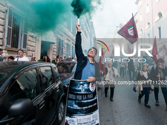 People participate in the demonstration "Italy repudiates war," which is the slogan of the procession that takes place in the streets of Rom...