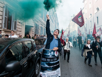 People participate in the demonstration "Italy repudiates war," which is the slogan of the procession that takes place in the streets of Rom...