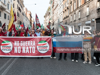 People participate in the demonstration "Italy repudiates war," which is the slogan of the procession that takes place in the streets of Rom...