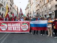 People participate in the demonstration "Italy repudiates war," which is the slogan of the procession that takes place in the streets of Rom...