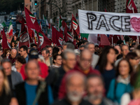 People participate in the demonstration "Italy repudiates war," which is the slogan of the procession that takes place in the streets of Rom...