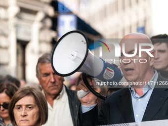 People participate in the demonstration "Italy repudiates war," which is the slogan of the procession that takes place in the streets of Rom...