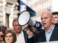 People participate in the demonstration "Italy repudiates war," which is the slogan of the procession that takes place in the streets of Rom...