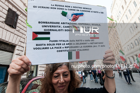 People participate in the demonstration "Italy repudiates war," which is the slogan of the procession that takes place in the streets of Rom...