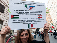 People participate in the demonstration "Italy repudiates war," which is the slogan of the procession that takes place in the streets of Rom...