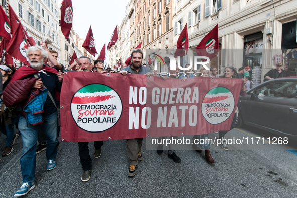 People participate in the demonstration "Italy repudiates war," which is the slogan of the procession that takes place in the streets of Rom...