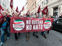 People participate in the demonstration "Italy repudiates war," which is the slogan of the procession that takes place in the streets of Rom...