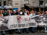 People participate in the demonstration "Italy repudiates war," which is the slogan of the procession that takes place in the streets of Rom...