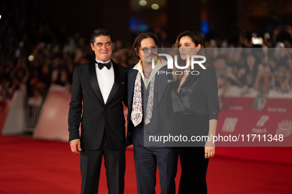 Riccardo Scamarcio, Johnny Depp, and Luisa Ranieri attend the ''Modi - Three Days On The Wing Of Madness'' red carpet during the 19th Rome F...